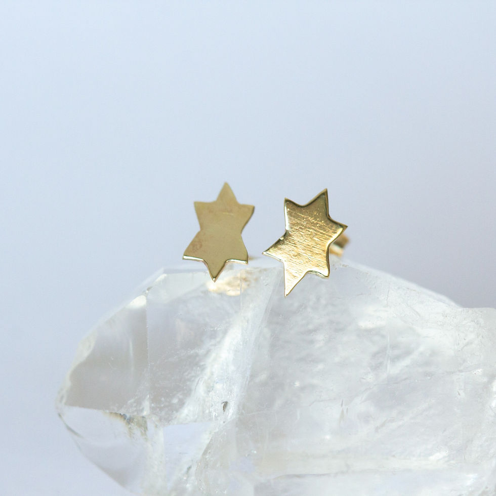 Small gold stud earrings star of david unique handcrafted jewelry from Jerusalem on a white and crystal background