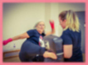 woman kicking the kickshield in a ladies only kickboxing class