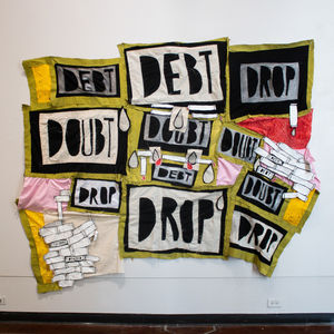 
A large tapestry featuring a vibrant collage of 2D pipes and scattered text in black, white, yellow, bright red, and a unique putrid green color. The words "Debt," "Doubt," and "Drop" are integrated into the composition, arranged in a way where each word is connected to each other and do not follow a set pattern.
