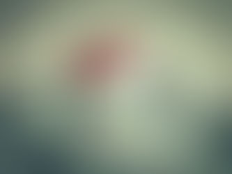 A small house with a red roof sitting on a pile of U.S. dollar bills.