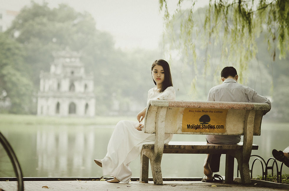 a woman and a man sitting on a bench