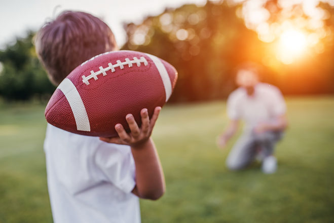 Football son and dad.jpeg