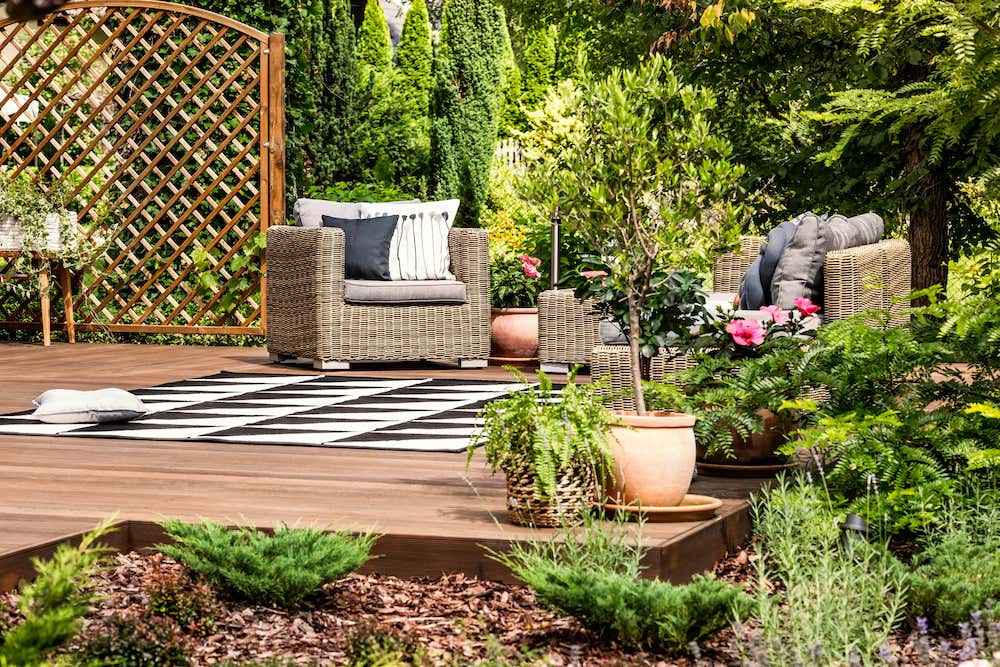 Patio set with chairs and table on a patio in a backyard garden