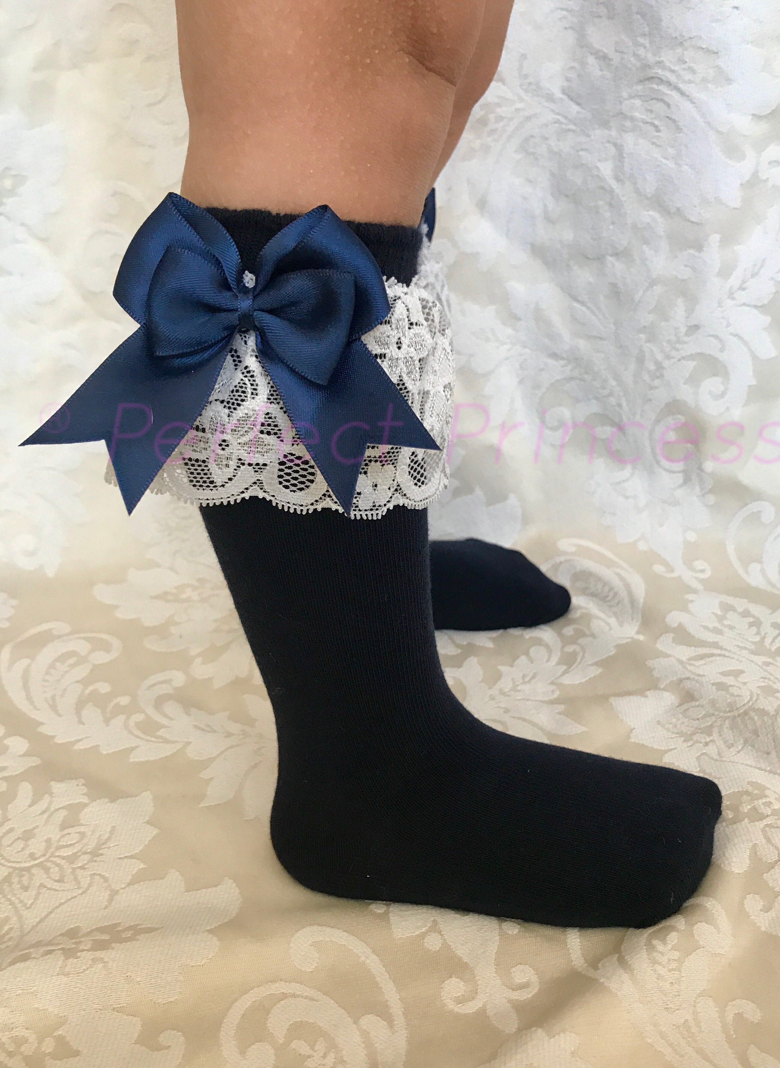 A neat stack of high-quality Spanish double bow socks in various colors.