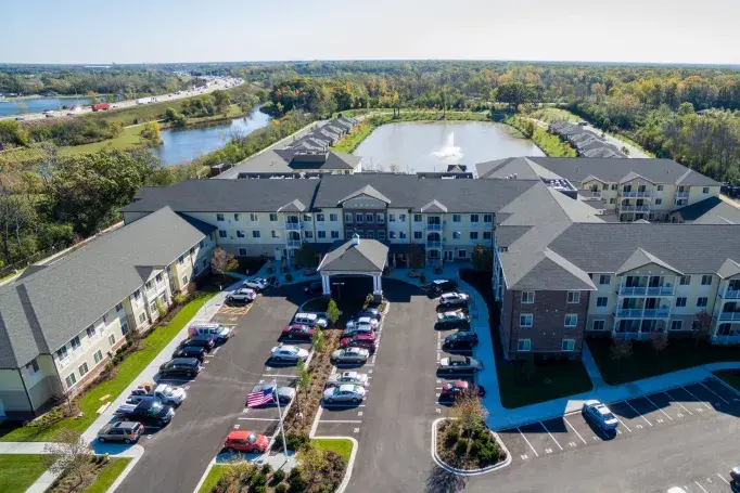 an aerial view of a large building with cars parked in front of it
