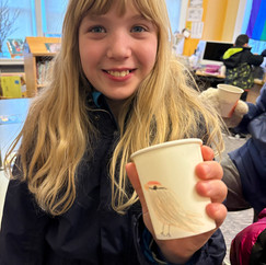 kid holding cup with bird seed
