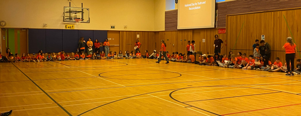 school children and staff gathering in the gym for NDTR and Orange Shirt Day