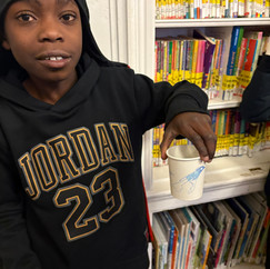 kid holding cup with bird seed