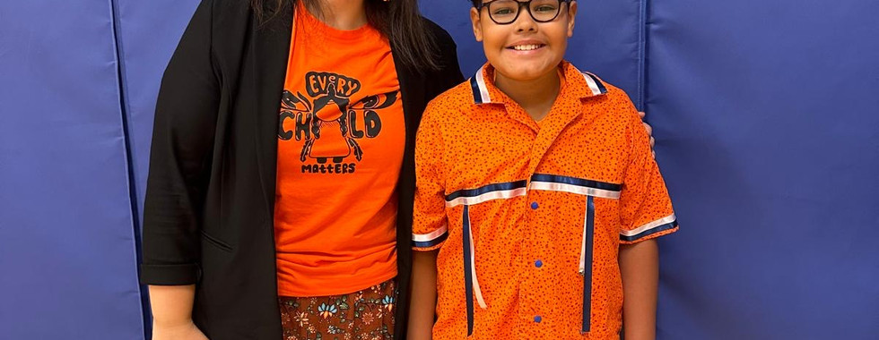 a JICS parent and her son in orange shirts