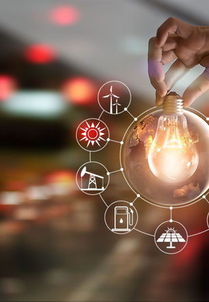 Hand holding a lightbulb with icons popping out of it.