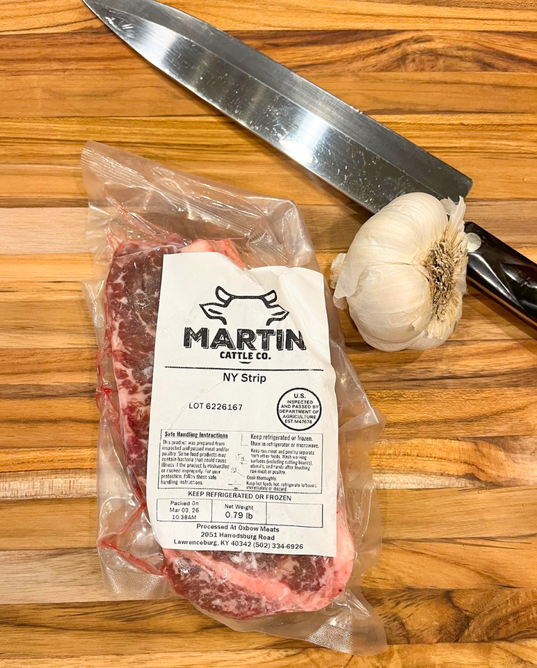 Martin Cattle Co. NY Strip steak with garlic and knife