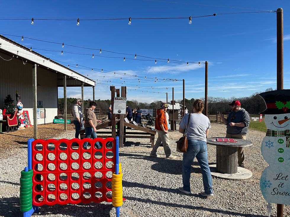 People at an outdoor employment event with lawn games.