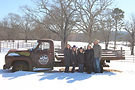 Prescott Family posing by a vintage farm truck in the snow