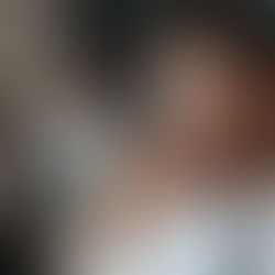 Leader standing before mirror with empowered reflection, symbolizing reflective leadership and continuous growth