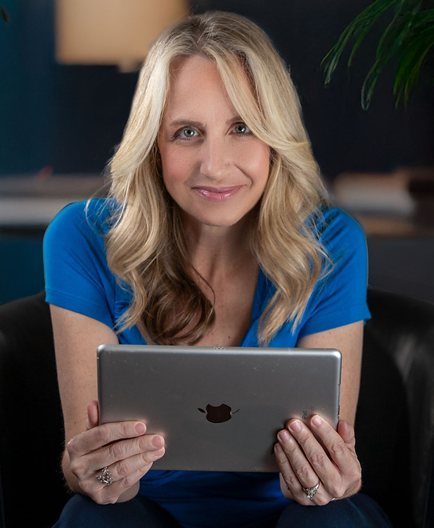Melanie Taylor Voice Actor holding an iPad