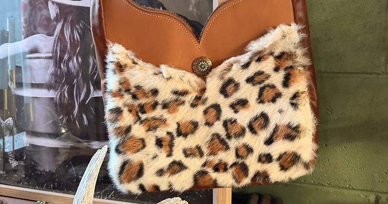 Handmade cowhide and genuine leather western clutch by Wyld Revolution Co featuring natural hair-on-hide leather.