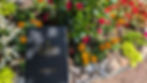 A Creative's Journal in front of flower garden