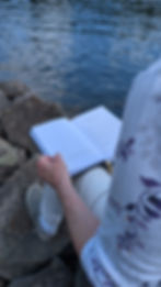 A Creative's Journal on Catherine's lap overlooking water