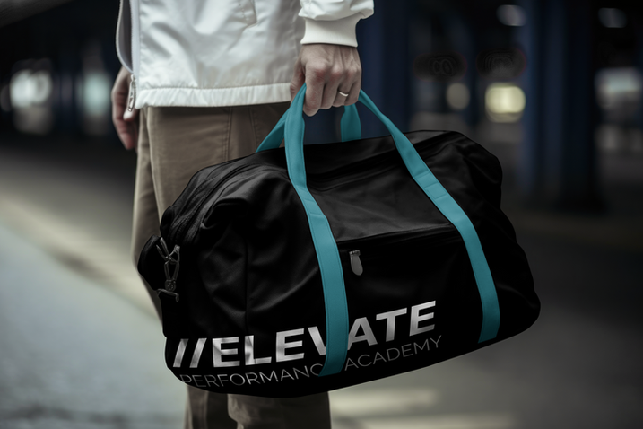 Custom black and teal gym duffel bag featuring the Elevate Performance Academy logo, held by an athlete.
