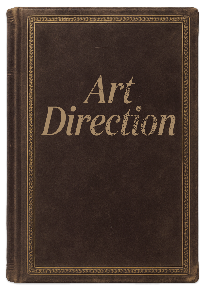 Leather-bound book titled Art Direction with ornate gold border design.