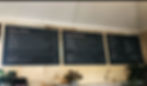 Wall-mounted menu boards displaying food and beverage options.