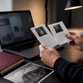 Photographer revising bio versions beside a print