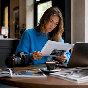 Photographer reading Canon contest rules at desk
