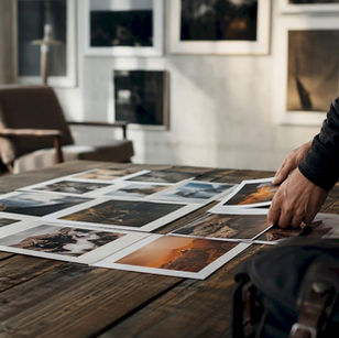 Hands selecting contest entry prints
