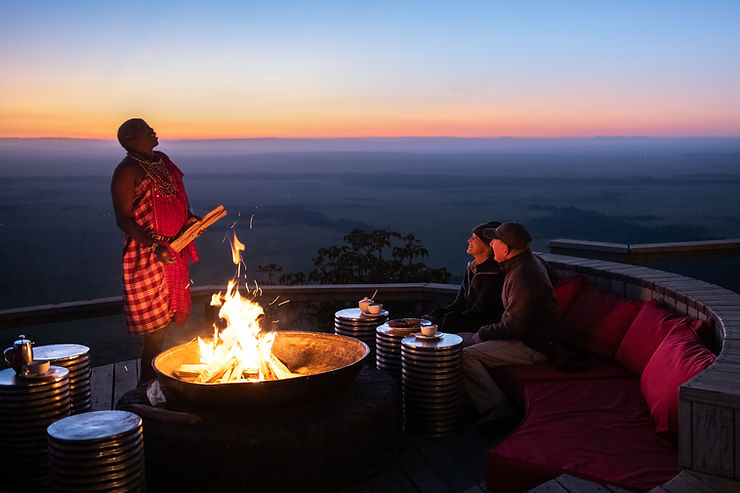 Kenyan Safari Dinner and Sundowners with guests and a traditional safari guide.