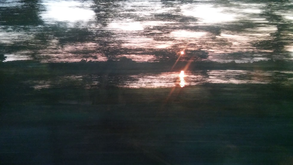 Riding on a train while the sun sets.