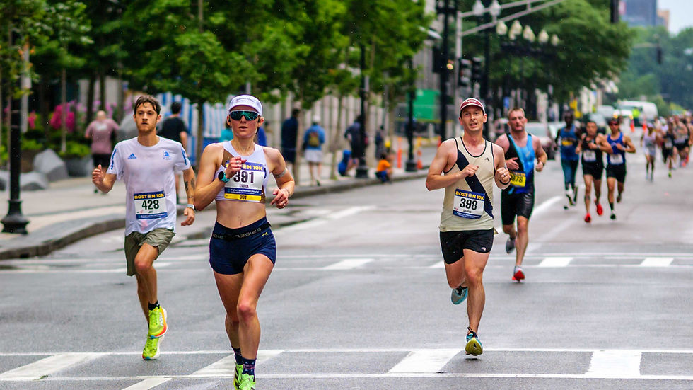 Emma Howe (391) leads a number of runners down Boylston Street at the Boston 10K on Sunday June 22, 2025.