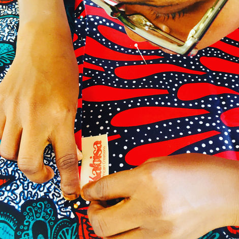 Diffence, Kabisa tailor positioning a label ready to be sewn in.