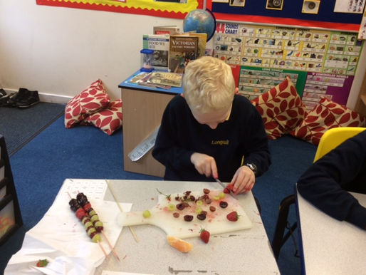Year 5 making fruit kebabs as part of healthy eating week... Delicious!