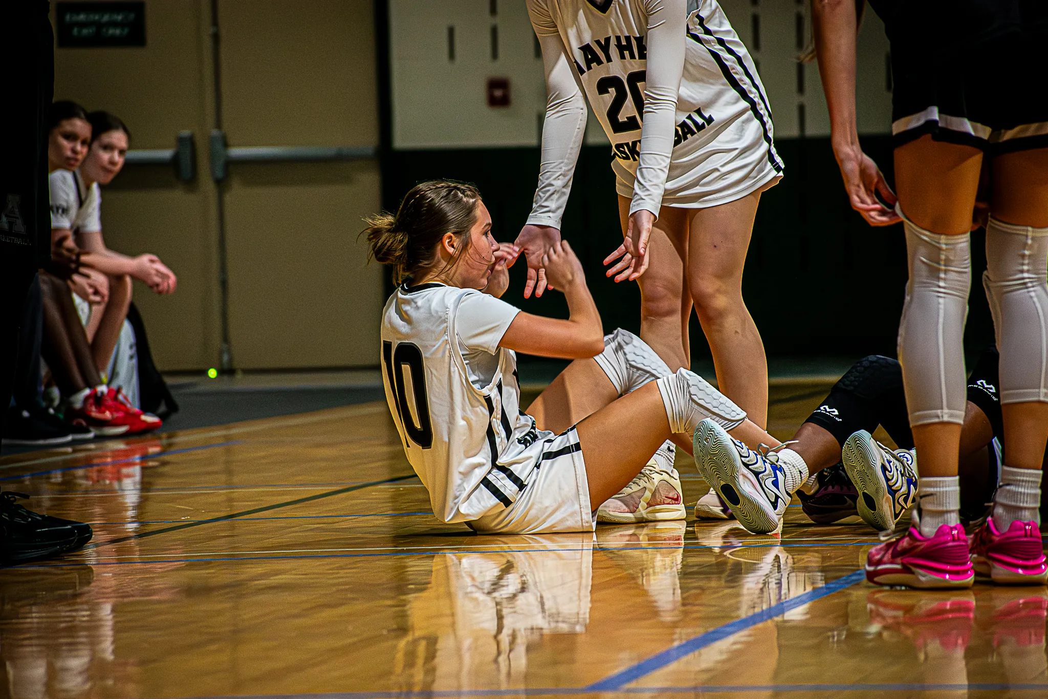 Mayhem player lifted from floor by her teammate.