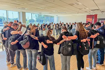 Texas Mayhem players, families, and coaches gathered in a pre-event prayer circle