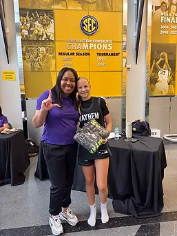 Texas Mayhem Premier player with an LSU women’s basketball staff member during a college team camp