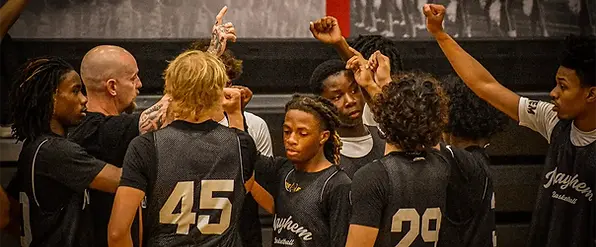 Texas Mayhem coaching staff and players posing after an AAU basketball tournament