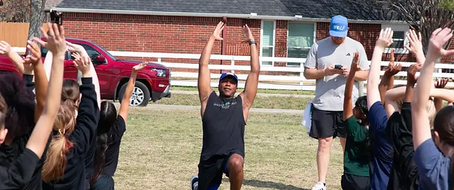 Coach Pruitt teaching how to stretch properly.