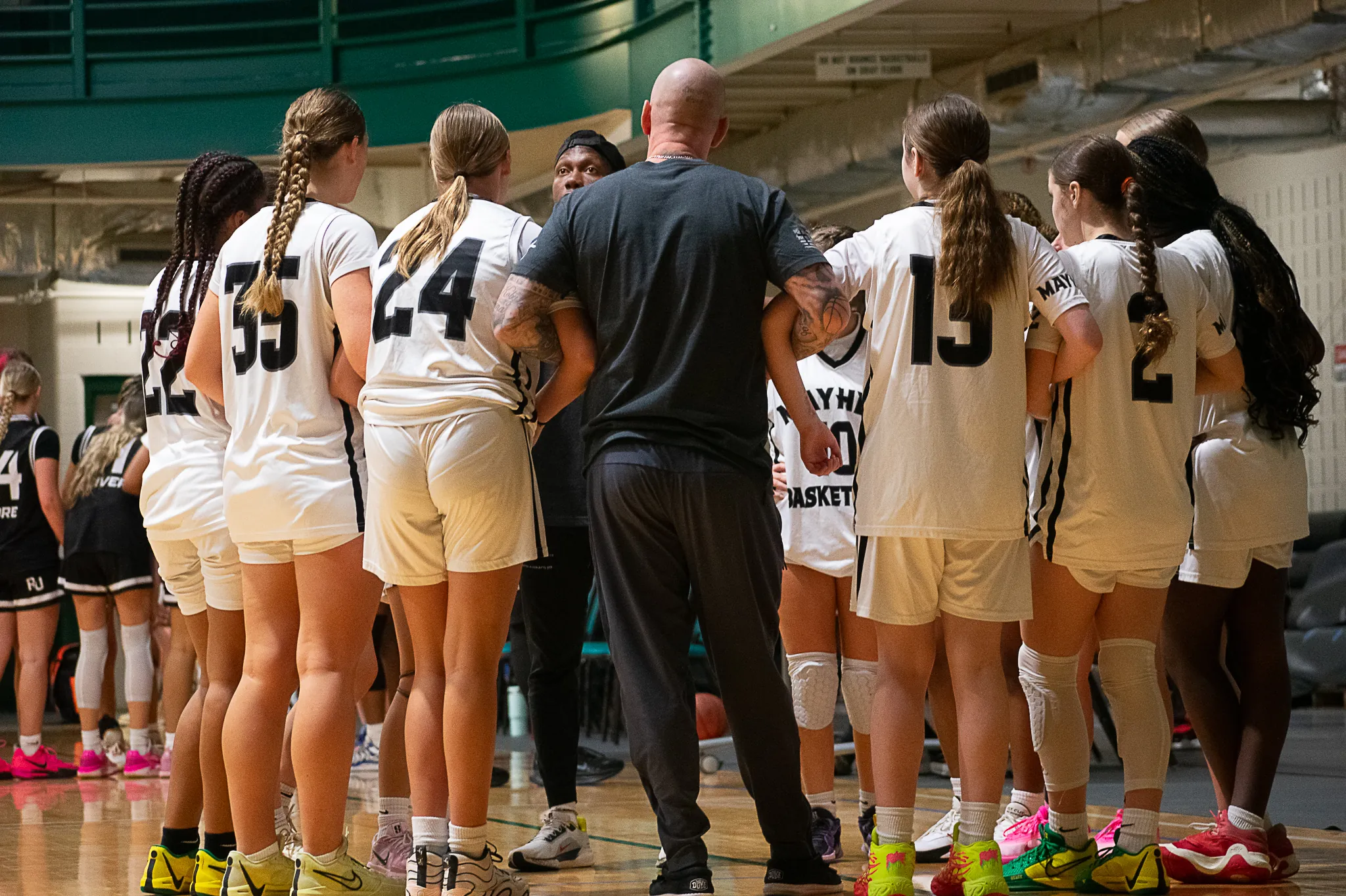Mayhem girls huddle at evaluation period.