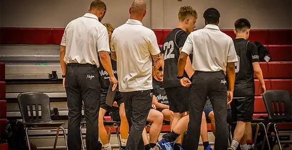 Mayhem coaches dressed in white polos and black dress pants