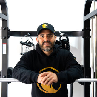 Rob Falcon smiling with fitness equipment.
