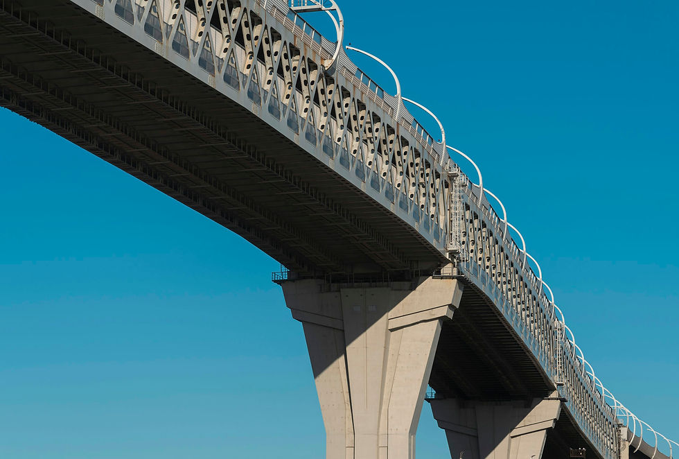 Concrete and steel bridge against a clear blue sky.