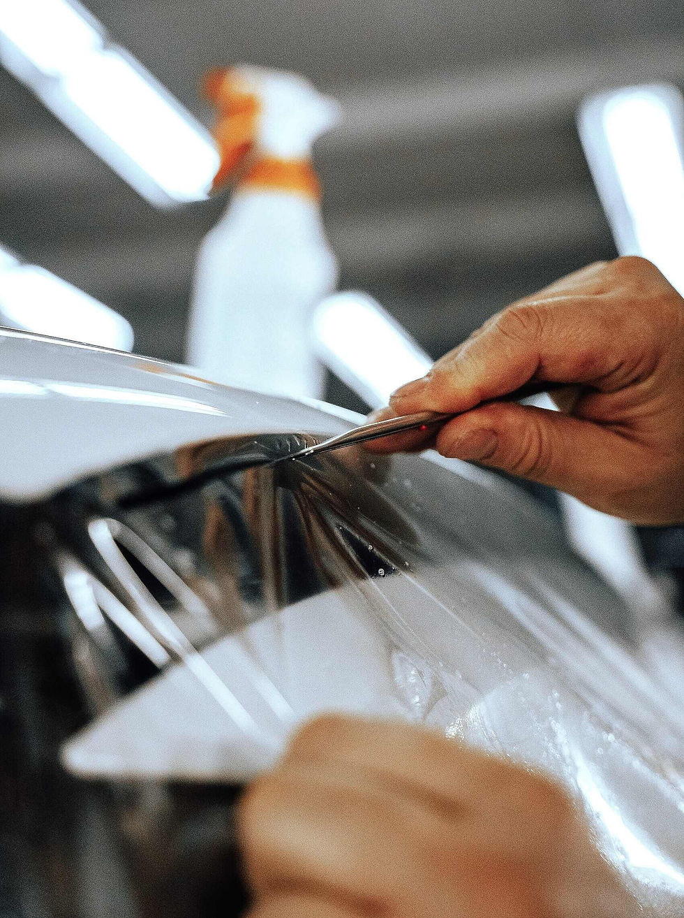 Deep gloss mirror reflection of a professional multi-layer ceramic coating treatment applied at our Bensenville shop, displaying intense water-beading performance.