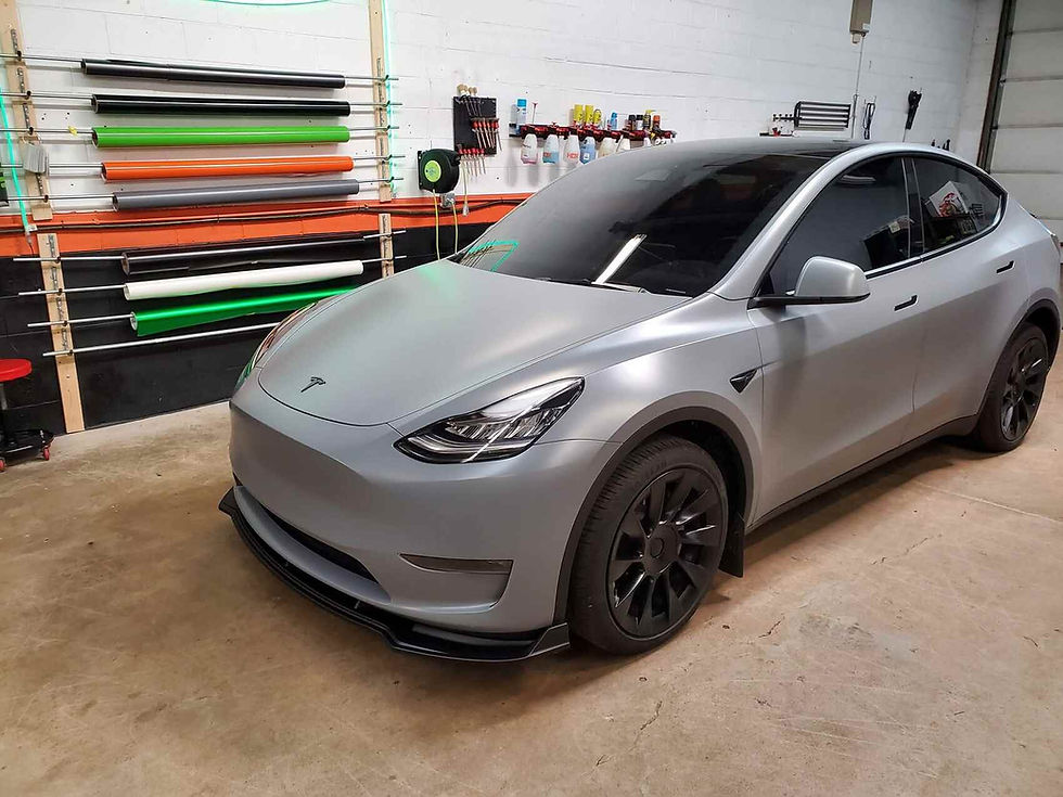 A Tesla parked outdoors showcasing a seamless, full-body color-change film from the $2,999 Tesla wrap package. The high-grade Auto Style film covers every exterior panel, delivering an aggressive custom aesthetic while shielding the factory finish underneath.