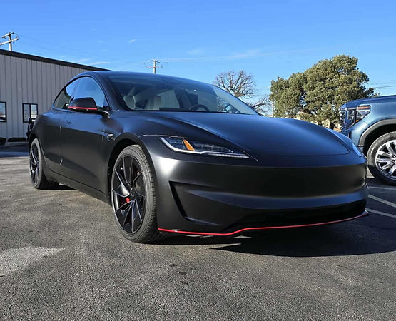 Close-up view of a vehicle panel showing the glossy, vibrant finish of Color Paint Protection Film (Color PPF) being applied