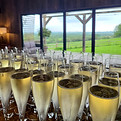 chilled flute glasses filled with champagne, on top of a bar
