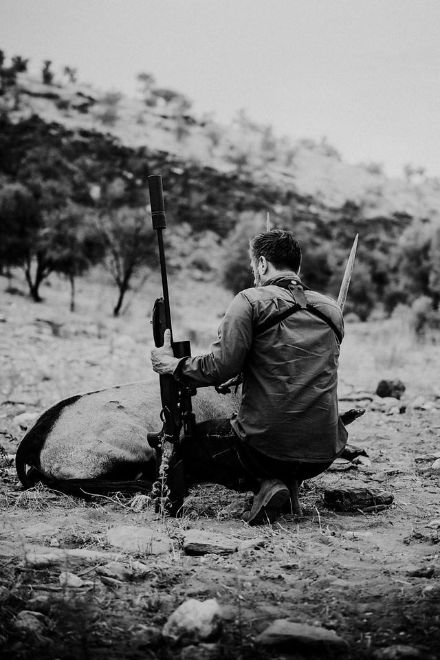 Huntsman And The Butcher hockt hinter der erlegten Oryxantilope in Namibia