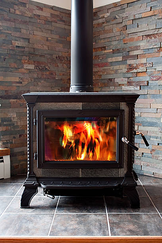 Wood stove insert installed in residential fireplace