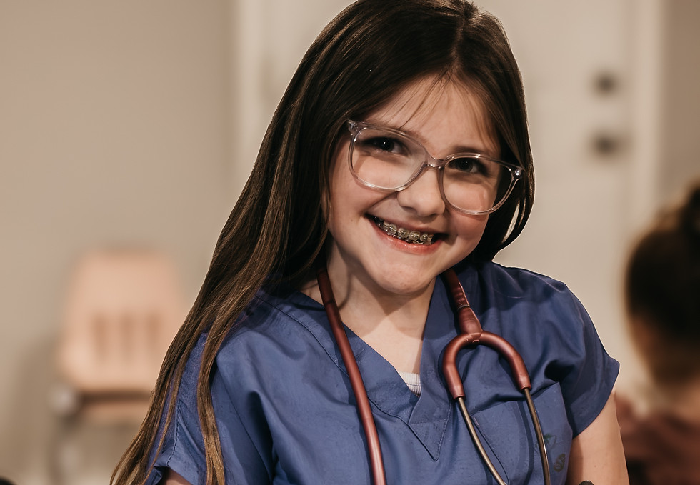 Smiling girl in scrubs and stethoscope