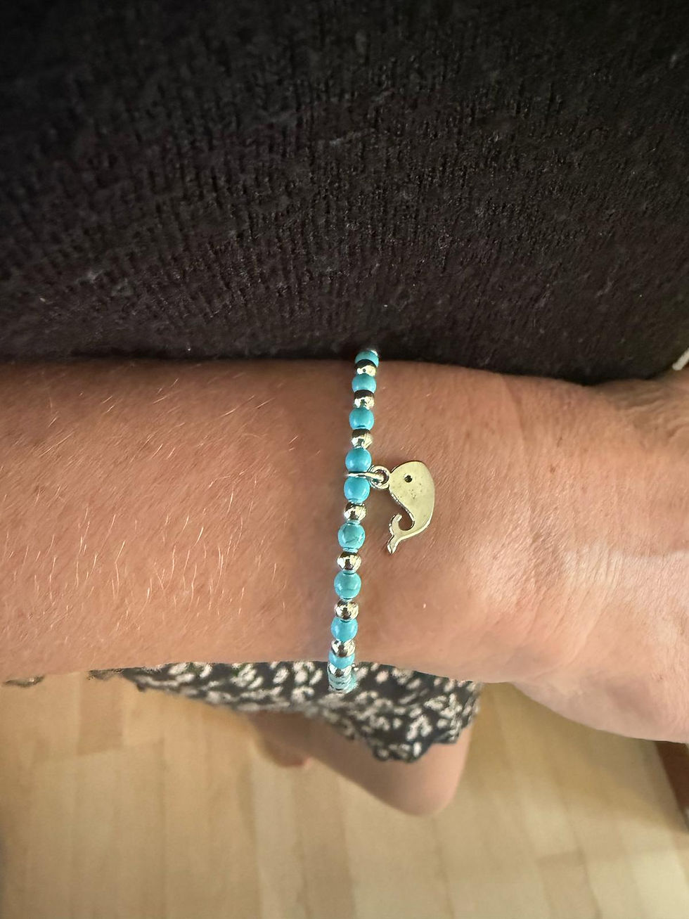 Thumbnail: silver charm bracelet on wrist